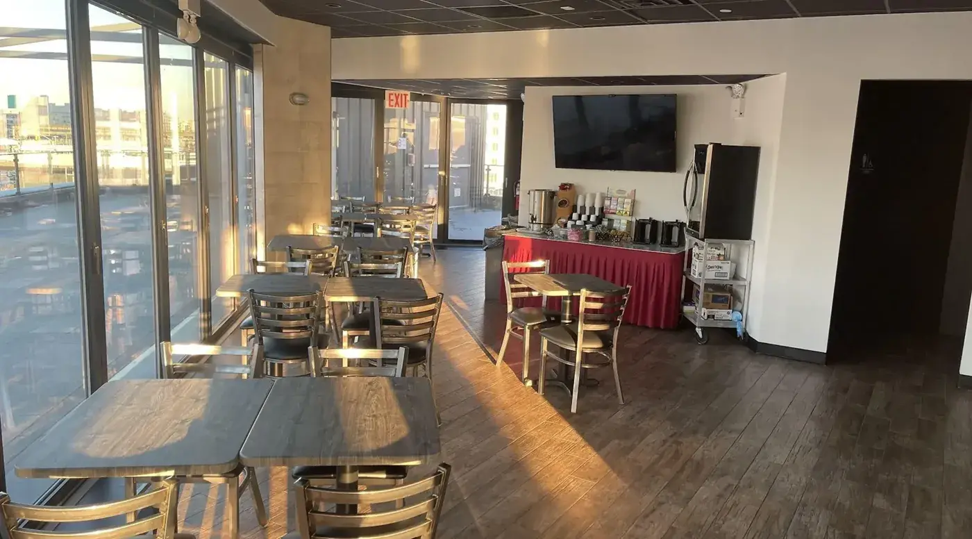 Dining room with tables by the windows and a coffee and tea table in the background