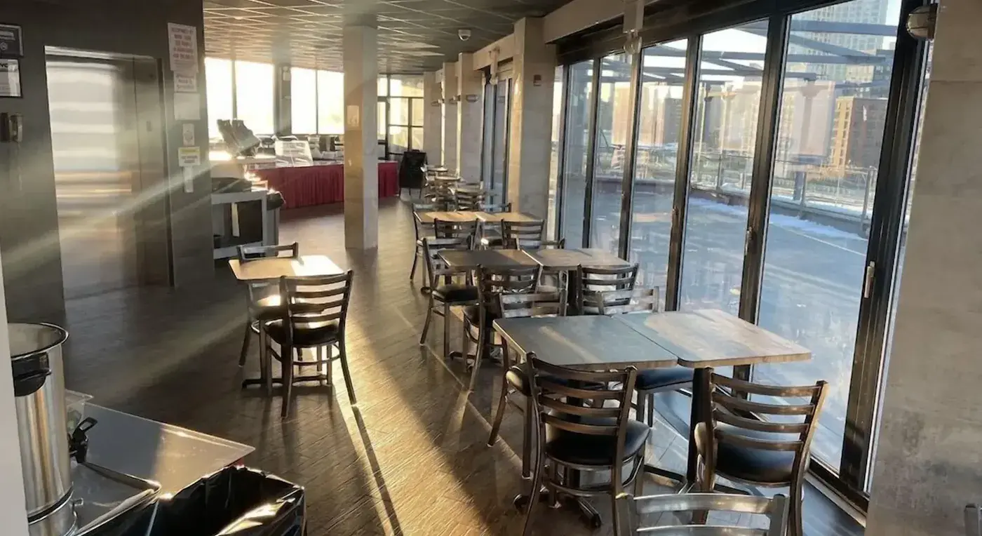 Dining room with windows onto the terrace and views of the city buildings